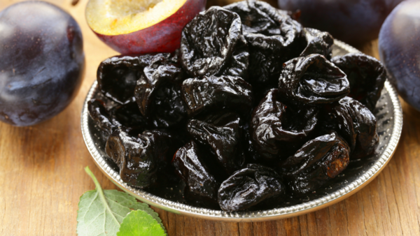 Close up of three prunes in a bowl