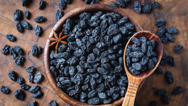 Close up of black raisins soaking in a bowl
